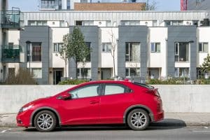 Parked red car showcasing the affect of an IVA on your car