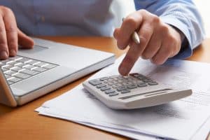 Man Working Out Household Finances showcasing what your IVA payment will be