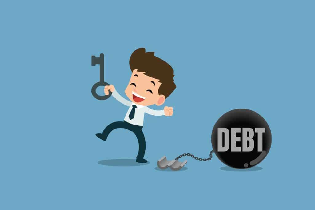 Happy man unlocks the chain from the steel metal ball to free debt illustrating pay an IVA off early
