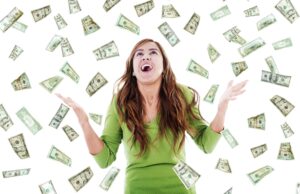 Happy woman trying to catch falling money showcasing what happens to a windfall in an IVA