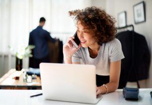 A female business owner using the laptop to showcase a company director starting an IVA